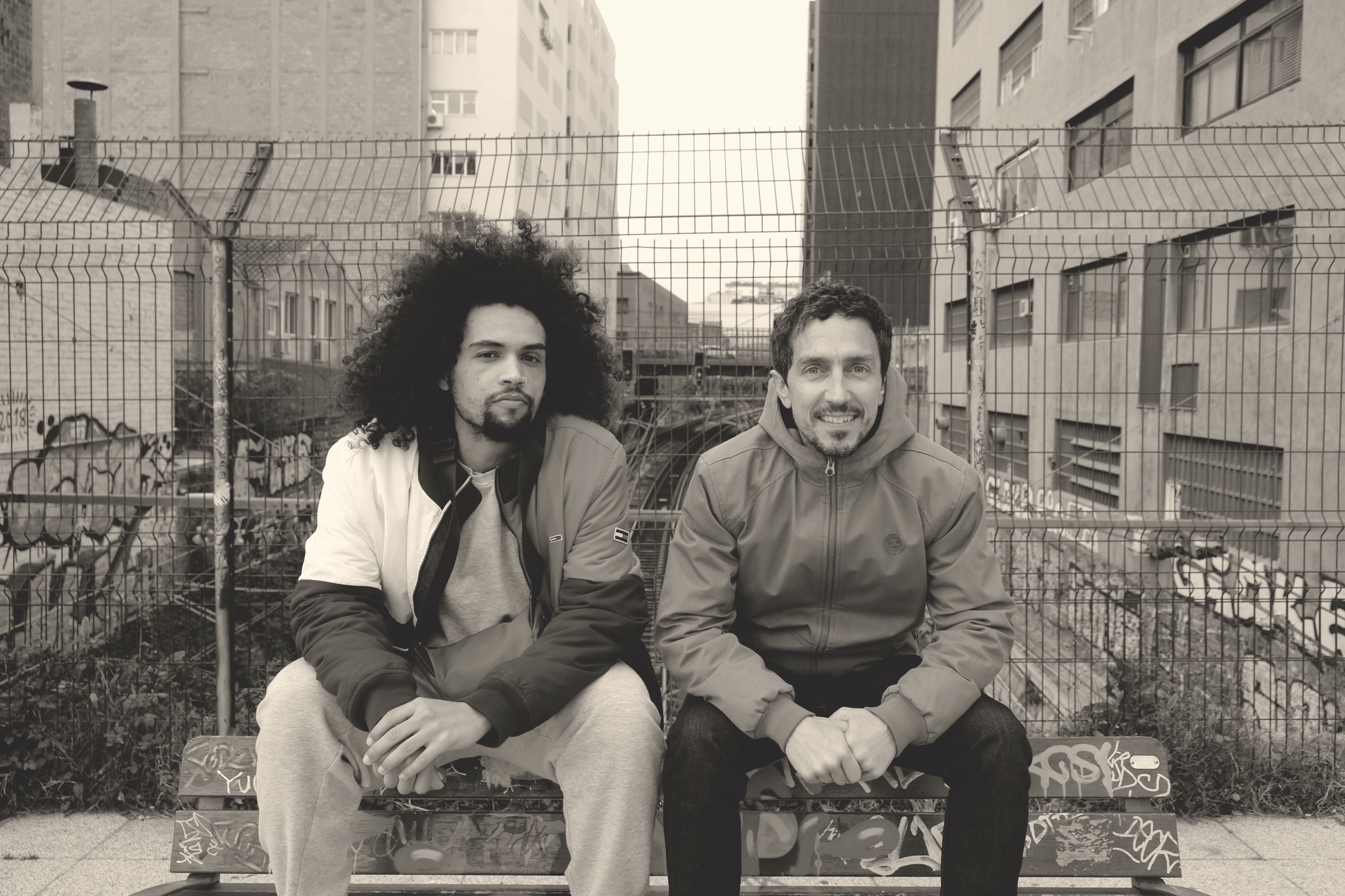 Wild Bounce sitting on a graffitied bench above the railway, Barcelona